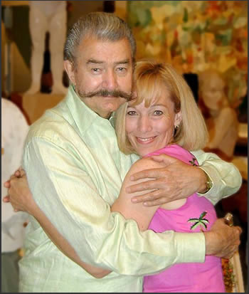 LeRoy Neiman hugs Neiman Originals owner Carla Bonney.